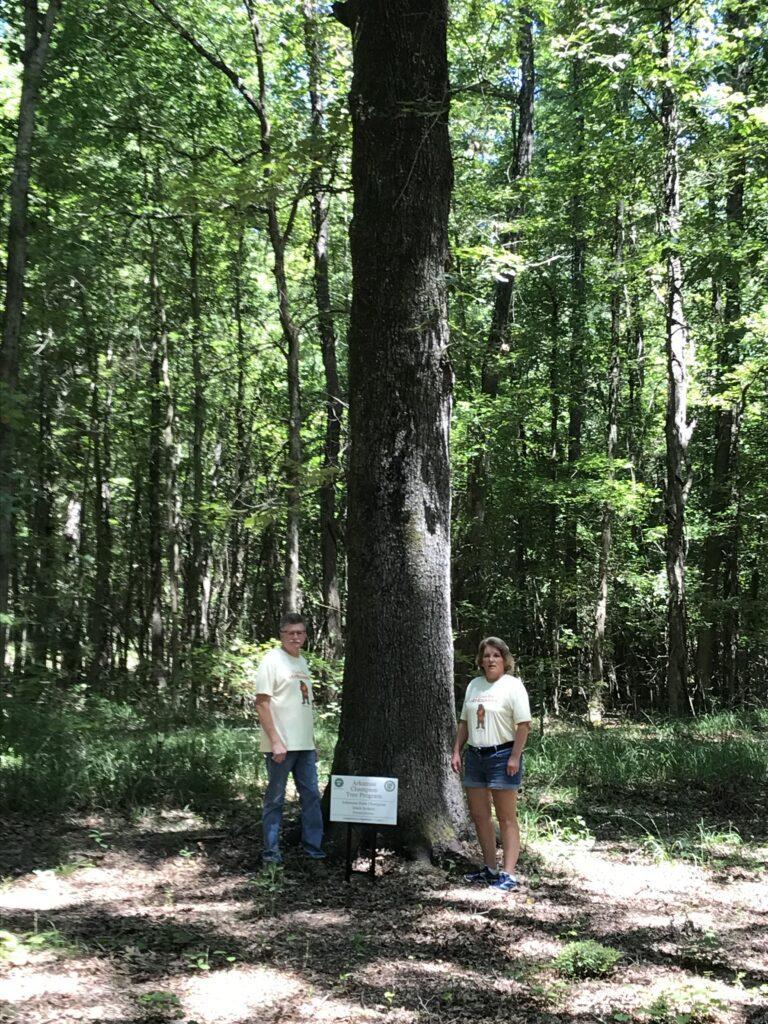 Champion black hickory sign with Michael and Celeste Abbott 1