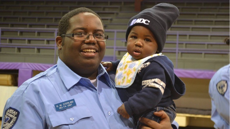 Correctional officer holding child