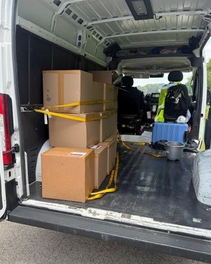 Photo shows boxes containing 150 pounds of marijuana in the back of a van.