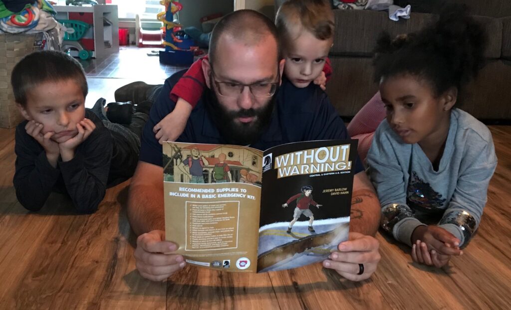 Without Warning Comic Book read to students by ADEM Employee Devin Dollar